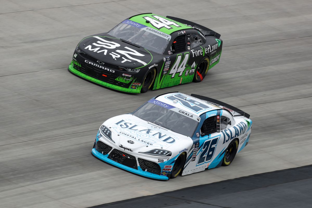 NASCAR Xfinity Series driver Kas Grala (26) races along side of driver Jeffrey Earnhardt (44) during the A-GAME 200 at Dover Motor Speedway.
