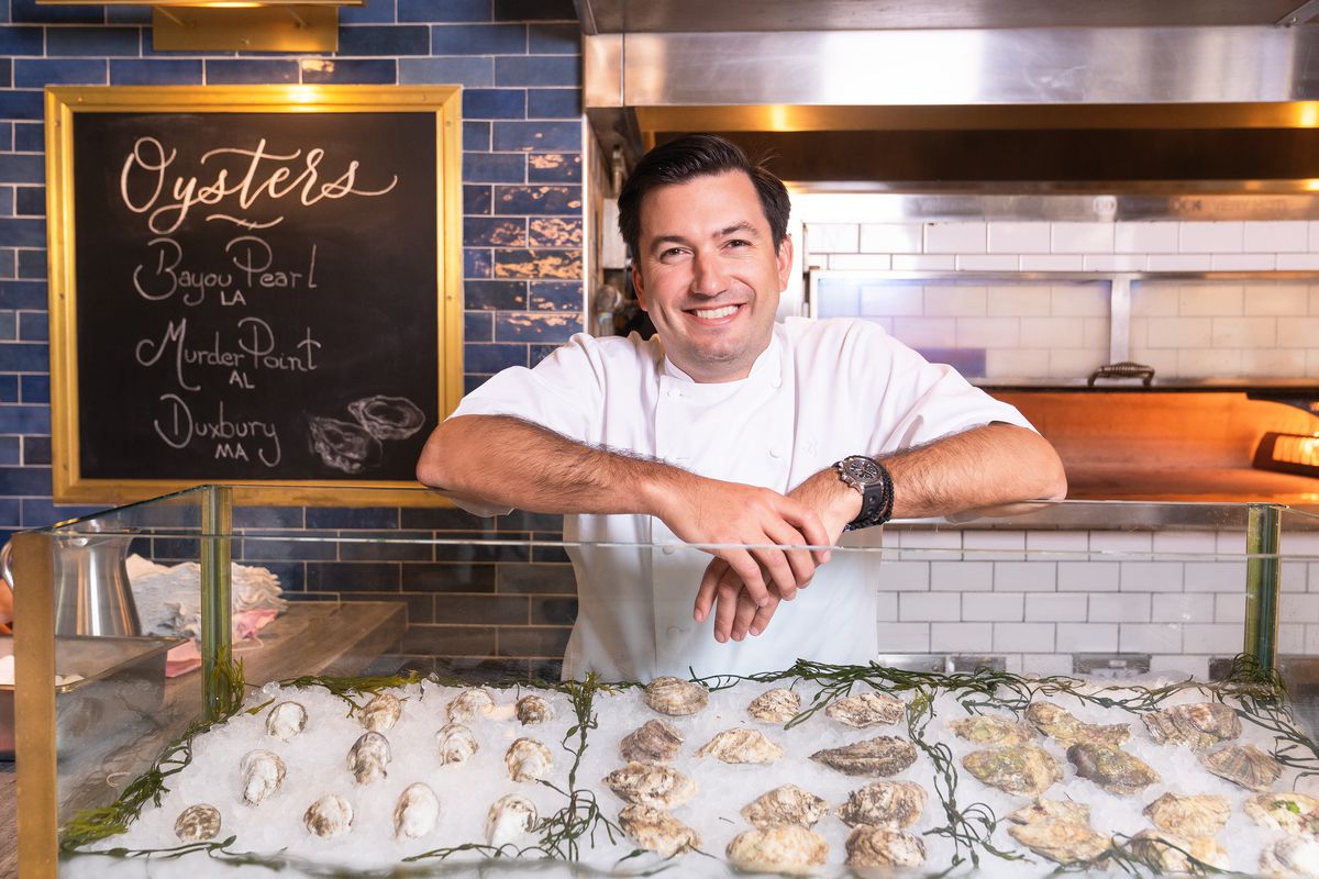 James Beard Award-nominated chef Aaron Bludorn poses in front of a raw bar.