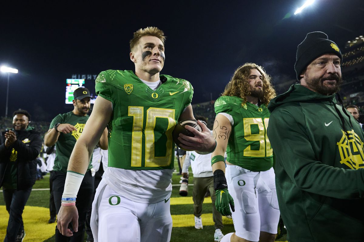 Oregon Ducks quarterback Bo Nix walks off the field with the game ball after defeating the Oregon State Beavers at Autzen Stadium.