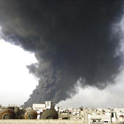 This Wednesday Feb. 15, 2012 file photo released by the Syrian official news agency SANA, shows black smoke rising from an oil pipeline, in Baba Amr neighborhood in Homs province, Syria. 