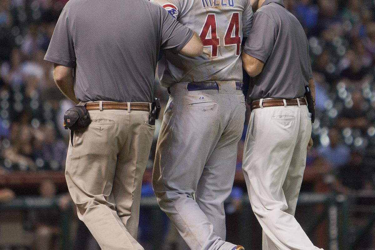 Anthony Rizzo of the Chicago Cubs is helped off the field by the training staff after tripping over first baseman Brett Wallace of the Houston Astros at Minute Maid Park in Houston, Texas. (Photo by Bob Levey/Getty Images)