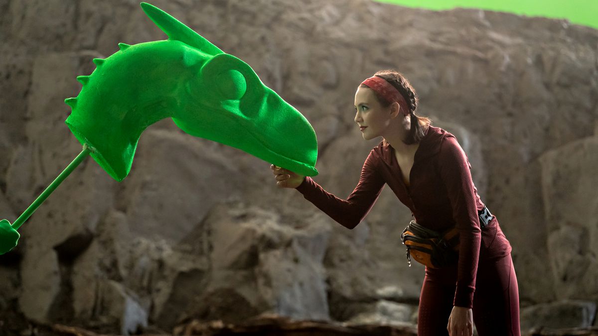 Idris Elba faces off against a bright green dinosaur prop in the fake movie Cliff Beasts 6, being made in the pandemic-era movie-about-moviemaking The Bubble