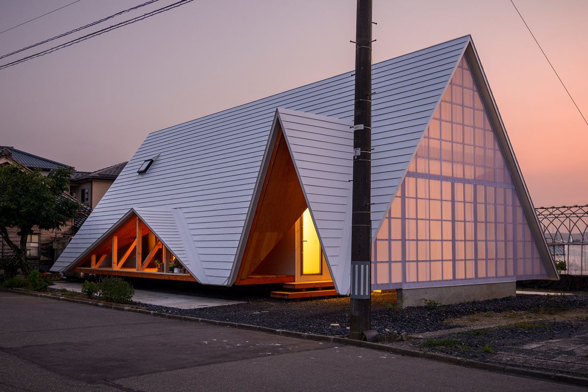 House shaped like a tent glowing at dusk.