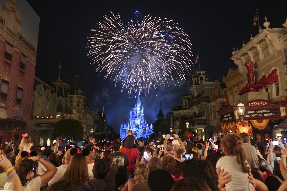 Fireworks explode over Cinderella’s Castle as visitors look on at Walt Disney World in Florida.