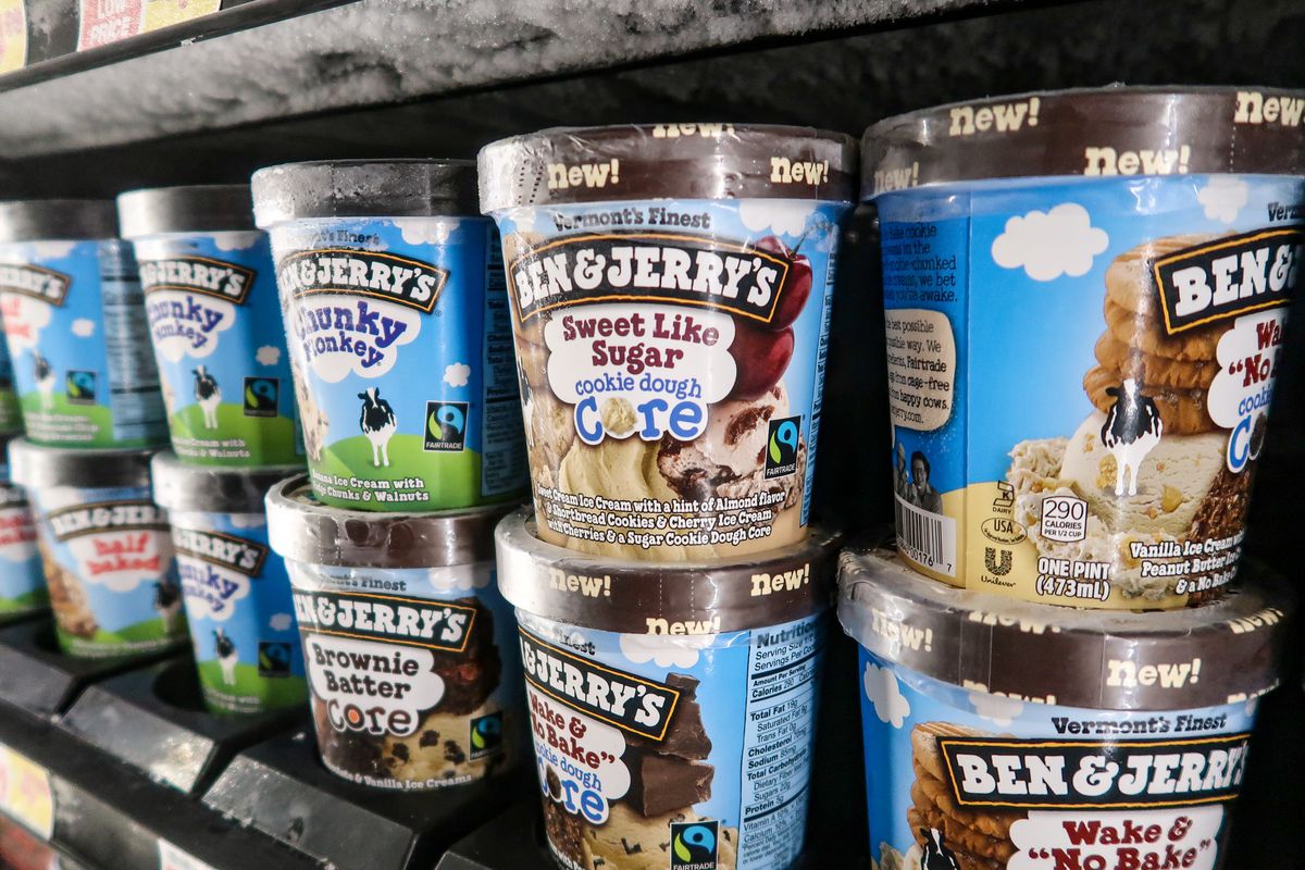 Two rows of Ben &amp; Jerry’s ice cream pints in a freezer shelf