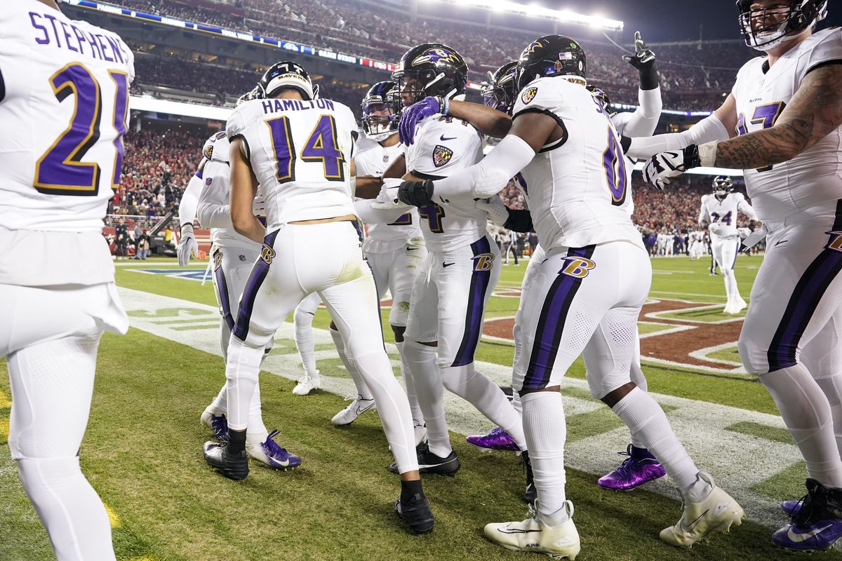 Kyle Hamilton #14 of the Baltimore Ravens celebrates with teammates after his interception during the first quarter against the San Francisco 49ers at Levi’s Stadium on December 25, 2023 in Santa Clara, California.