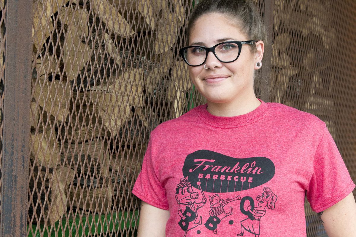 a girl wears a pink T-shirt from Franklin BBQ
