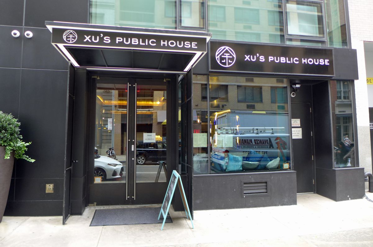 A black restaurant facade that says Xu’s Public House...