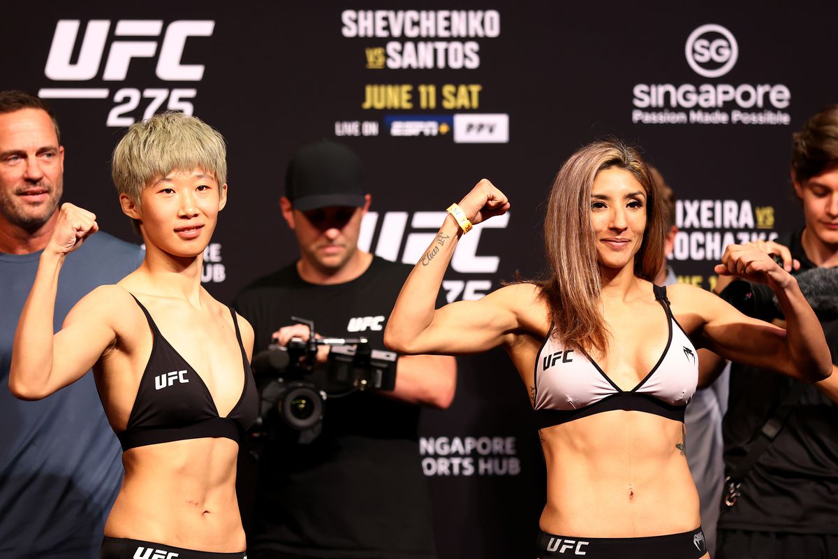 Liang Na of China and Silvana Gomez Juarez of Argentina pose for photos ahead of their strawweight bout during the UFC 275 Weigh-in at Singapore Indoor Stadium on June 10, 2022 in Singapore.