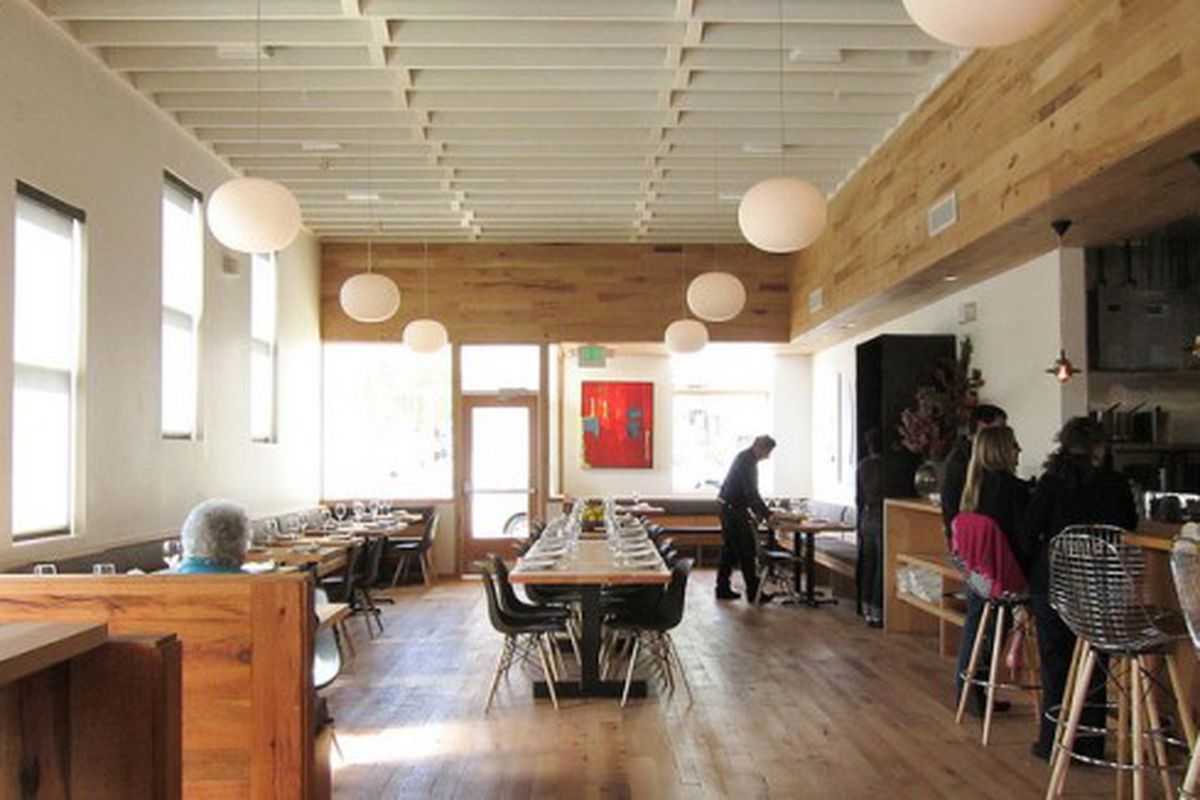 Long cypress wood communal tables, hanging orb lights and white ceiling rafters mark the interior. The new Piccino seats almost 100 people. <br />(c) Jennifer Yin / Eater SF