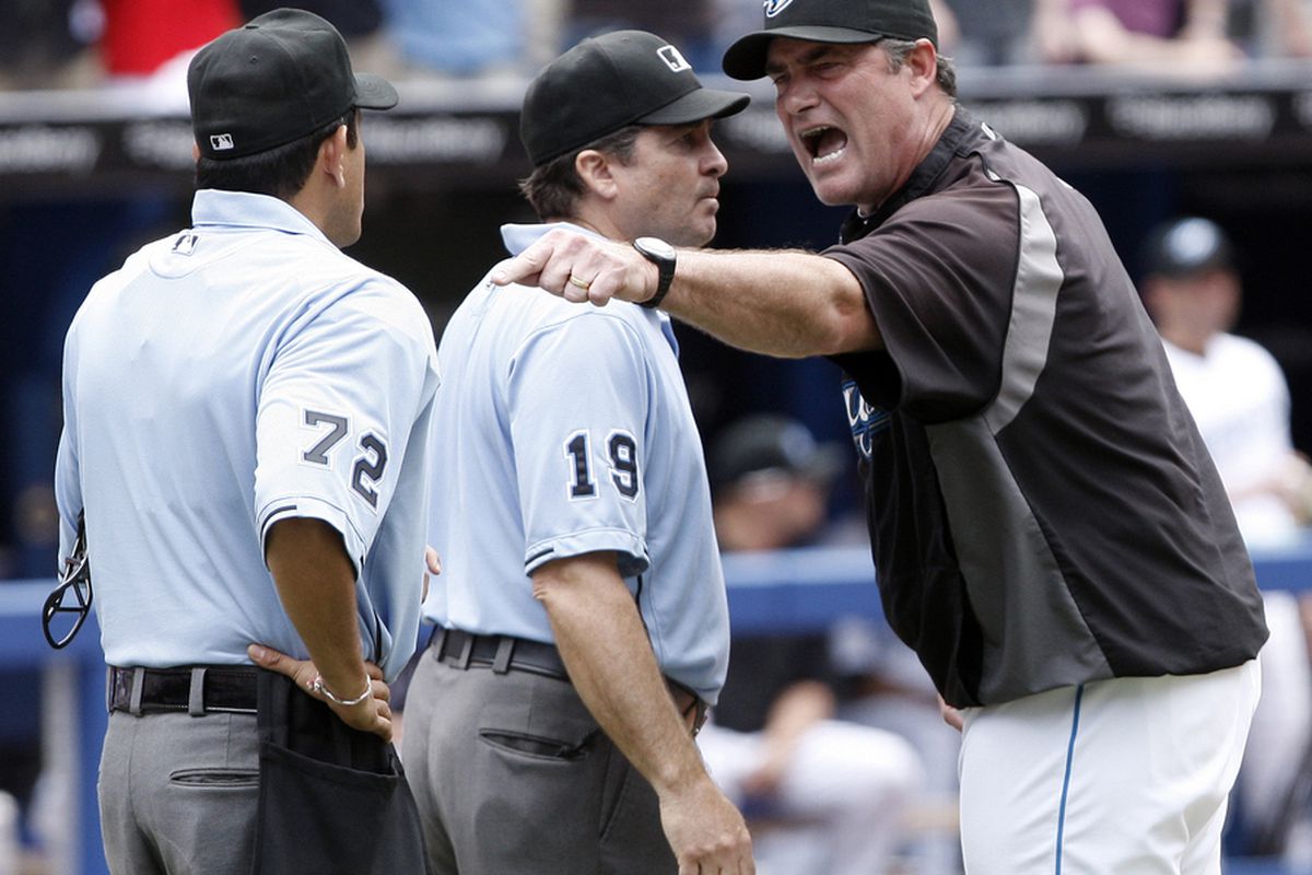 TORONTO, CANADA - JULY 2: Manager John Farrel argues with Umpire Alphonso Marquez and Ed Hickox during MLB action at The Rogers Centre July 2, 2011 in Toronto, Ontario, Canada. (Photo by Abelimages/Getty Images)