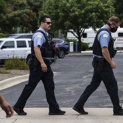 Chicago police officers leave the Cook County medical examiner’s office Tuesday afternoon, July 28, 2020. CPD Deputy Chief Dion Boyd was found dead in his office that morning of an apparent suicide.
