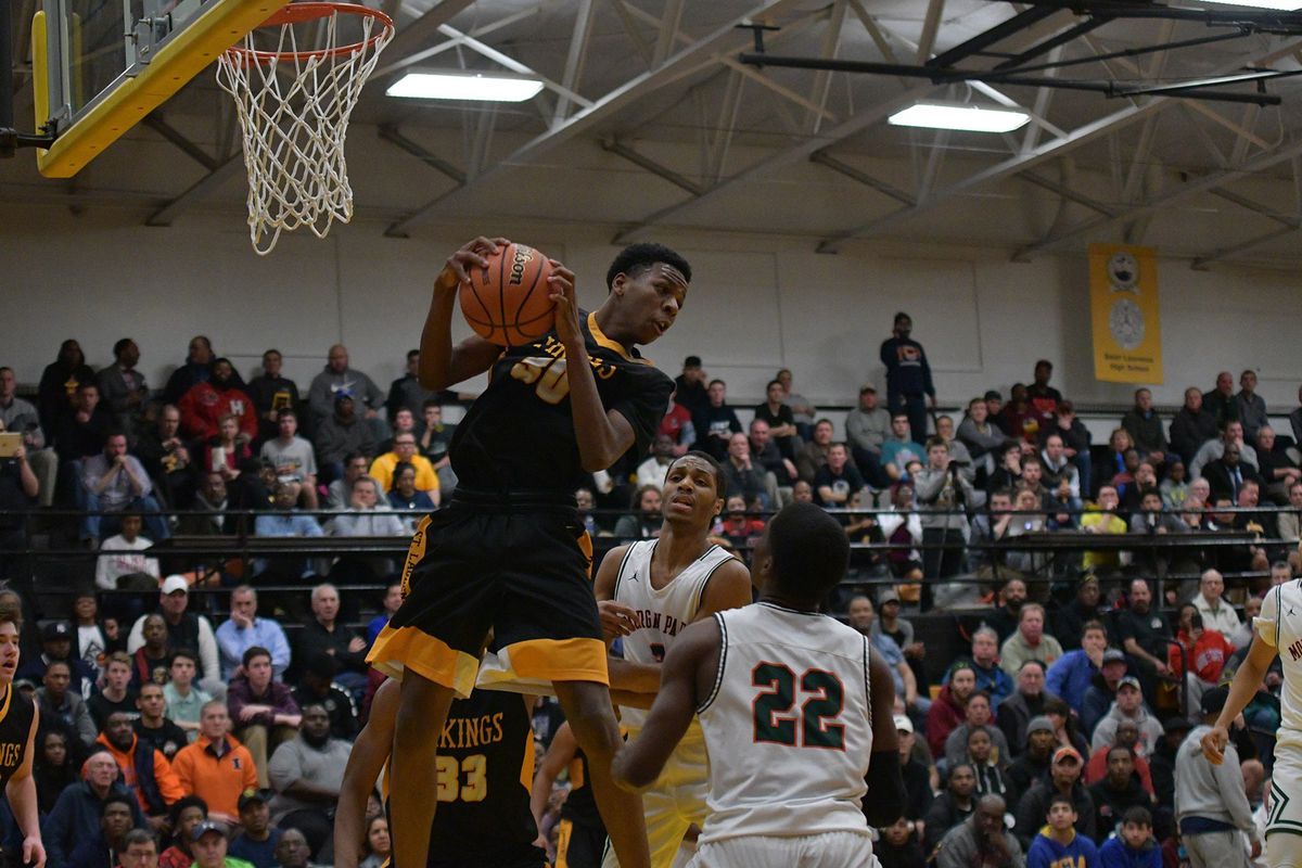 St, Laurence’s Jeremiah Williams (30) hauls in a rebound against Morgan Park. Worsom Robinson/For the Sun-Times.