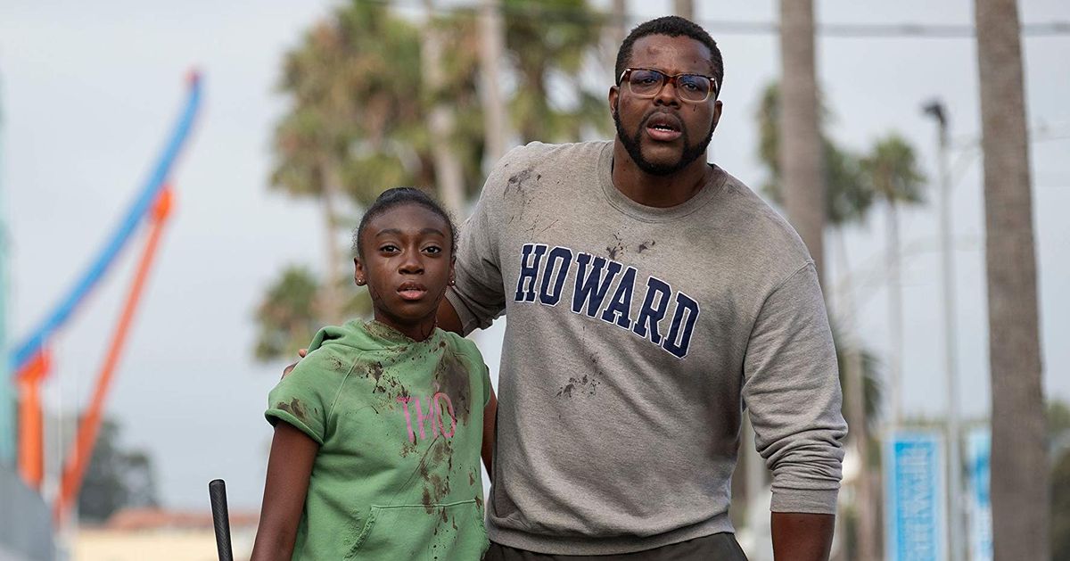 Gabe (Winston Duke) and Zora (Shahadi Wright Joseph) look out in horror in a screenshot from Us.