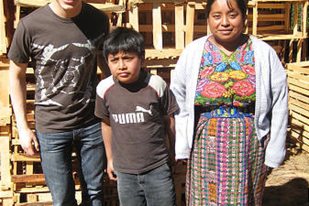 David Archuleta, left, poses with Imelda Odgas and her nephew Ronnie, who are Guatemalan clients of the Utah-based microfinance organization Mentors International.