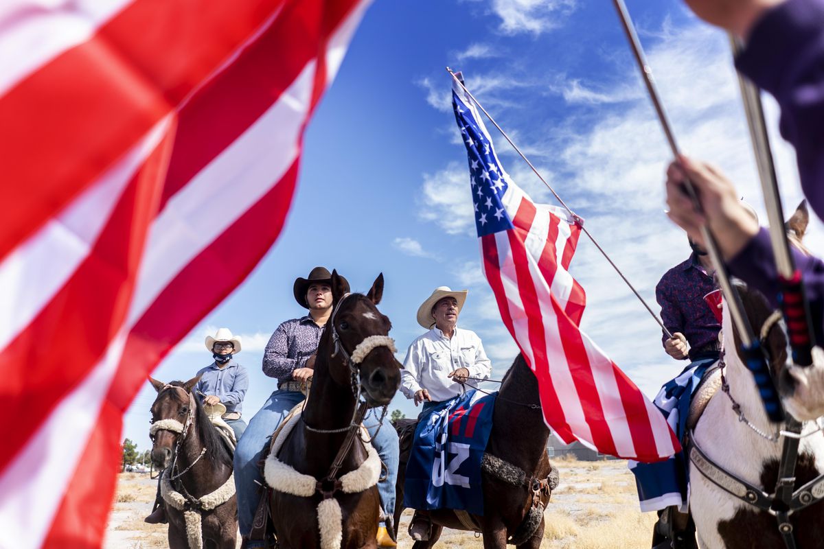 Latino supporters attend a Biden/Harris Nevada Hispanic Legislative Caucus and supporters on horseback rally at the Walnut Community Center’s early voting location in Las Vegas, Nevada on Saturday, October 24, 2020.