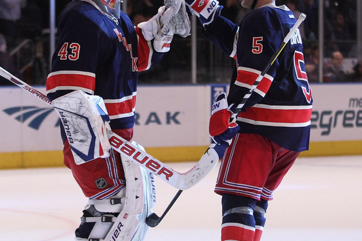 Dan Girardi (5) of the New York Rangers congratulates Martin Biron (43) on his 3-0 shutout over the Winnipeg Jets at Madison Square Garden on November 6, 2011 in New York City.  (Photo by Bruce Bennett/Getty Images)