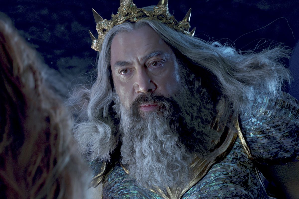 Javier Bardem as King Triton, looking sternly at Ariel