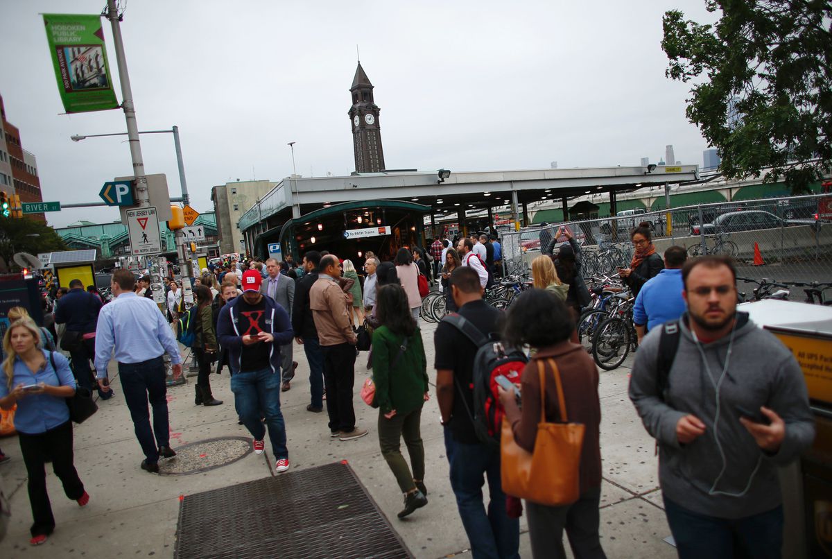 Commuters gather at New Jersey Transit’s rail station in Hoboken, New Jersey on Thursday. A commuter train crashed into the station during the morning rush hour on Thursday, officials said, with more than a hundred people injured. | Kena Betancur/AFP/Gett