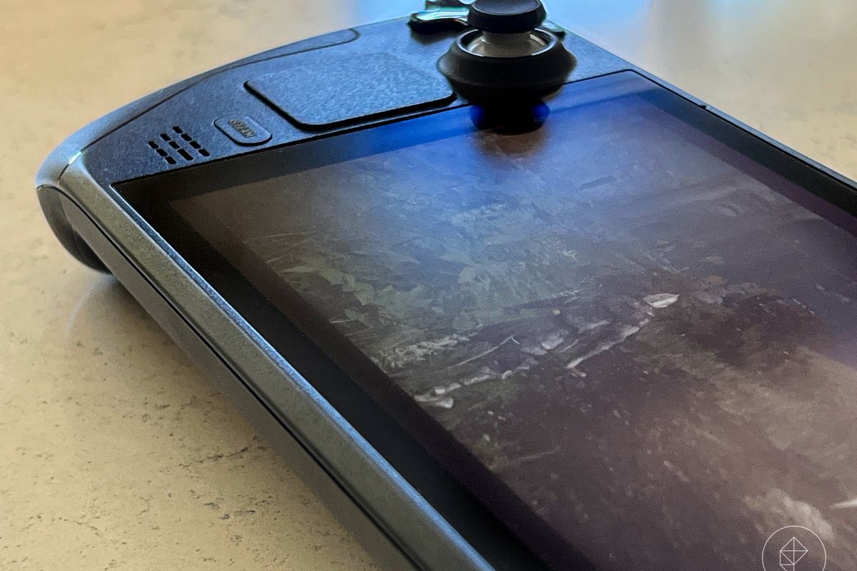Close up photo of Steam Deck hand-held gaming device on stone surface