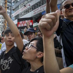 Protesters gestures during a march on a street in Hong Kong, Sunday, July 21, 2019. Thousands of Hong Kong protesters marched from a public park to call for an independent investigation into police tactics. (AP Photo/Vincent Yu)