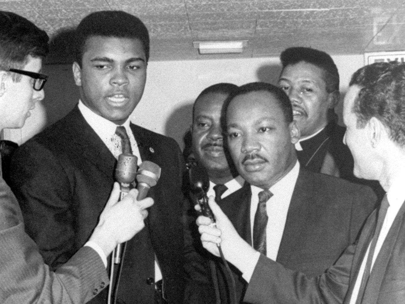 In this March 29, 1967, file photo, heavyweight champion Muhammad Ali and Dr. Martin Luther King speak to reporters. 