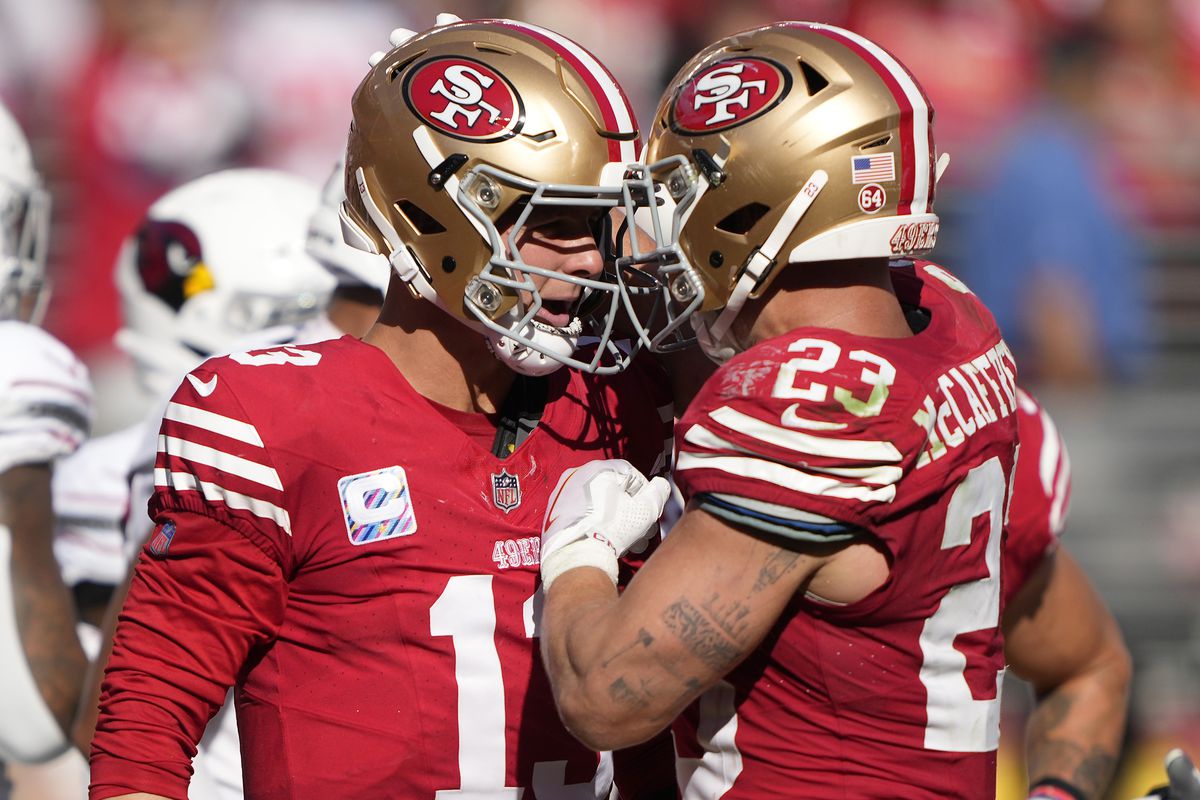 Brock Purdy #13 of the San Francisco 49ers celebrates his rushing touchdown with Christian McCaffrey #23 during the fourth quarter against the Arizona Cardinals at Levi’s Stadium on October 01, 2023 in Santa Clara, California.