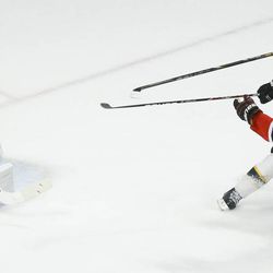 Chicago Blackhawks center Jonathan Toews (19) shoots the puck wide against Boston Bruins goalie Tuukka Rask (40) as Boston Bruins defenseman Andrew Ference (21) defends in the third period during Game 2 of the NHL hockey Stanley Cup Finals, Saturday, June 15, 2013, in Chicago.