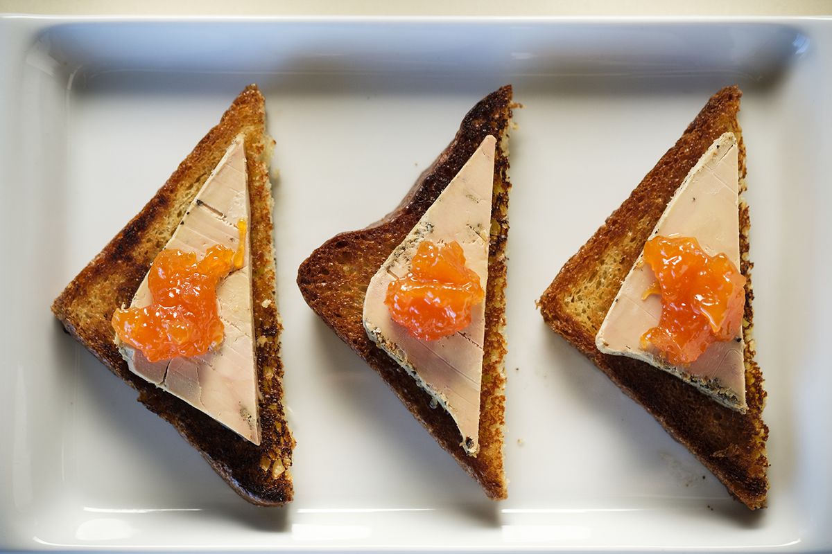 Three triangles of Foie Gras Pastrami with Toasted Brioche and Mostarda.&nbsp;