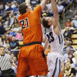 Brigham Young Cougars guard Skyler Halford (23) drives by Pacific Tigers forward Jacob Lampkin (21) at the Marriott Center Saturday, Feb. 14, 2015. BYU beat the Tigers, 84-59.