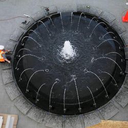Workers adjust a fountain in the main lobby of the new Nu Skin building in Provo on Tuesday, June 11, 2013.