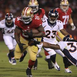 Denver Broncos strong safety David Bruton (30) gets an arm on San Francisco 49ers running back Anthony Dixon (24) before the play is called back on a penalty during the fourth quarter at Candlestick Park. The Denver Broncos defeated the San Francisco 49er