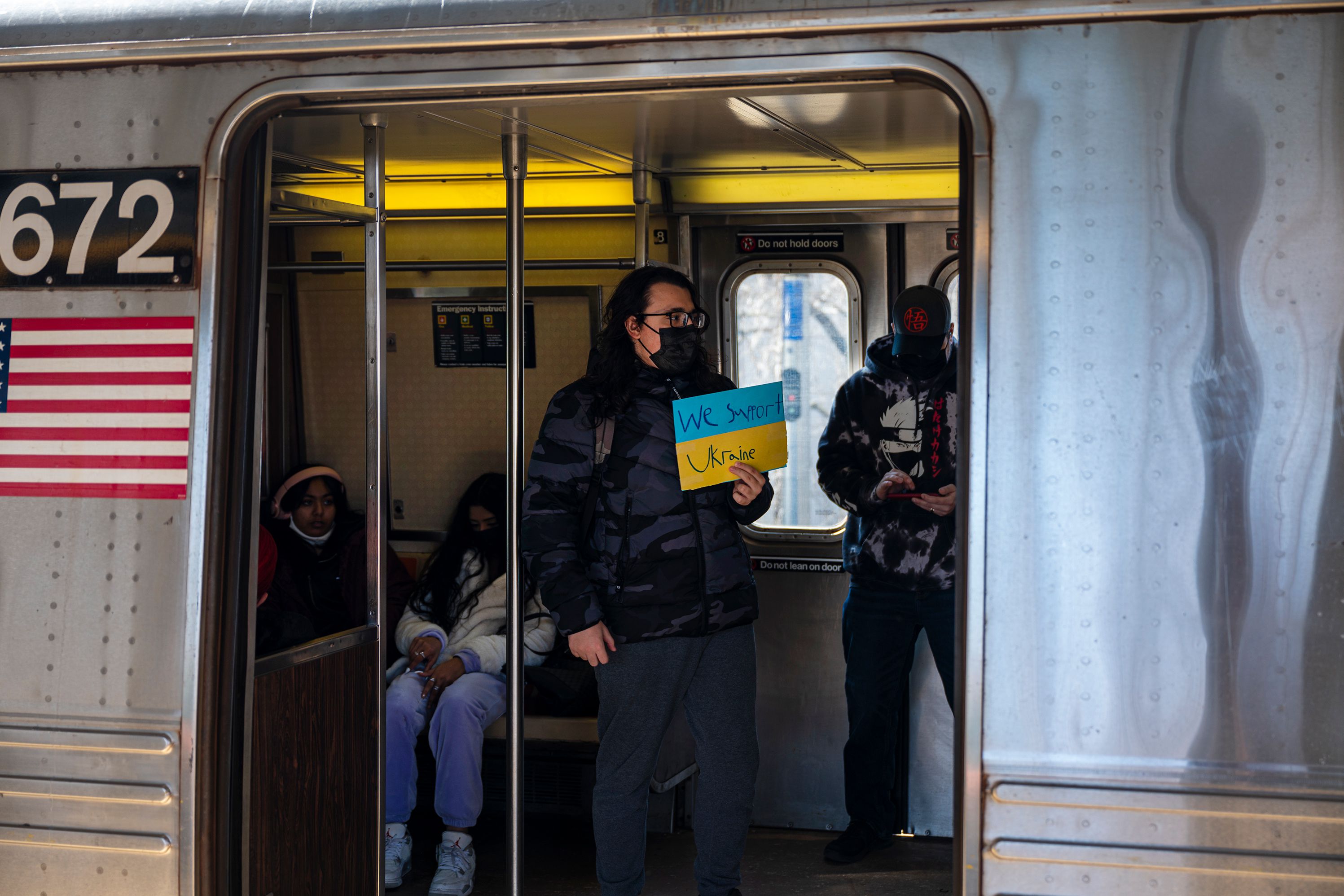 A Ukraine supporter rides a Q train from Brighton Beach, March 11, 2022.