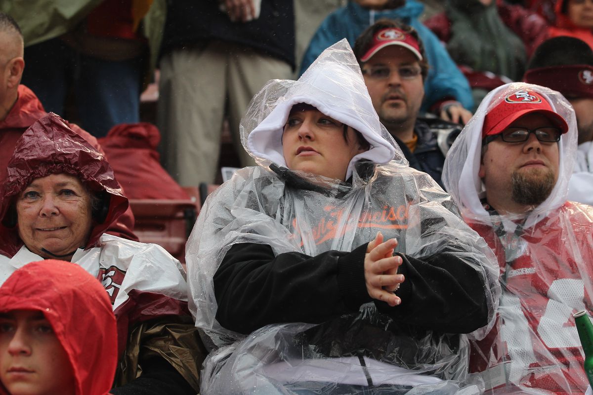 &nbsp;Football fans sit in the rain before the start of the NFC Championship Game against the San Francisco 49ers at Candlestick Park on January 22, 2012 in San Francisco, California.
