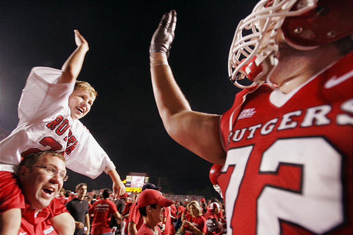 Rutgers' Mike Fladell (72) celebrates with fans on the field after beating South Florida 30-27, ending the Bulls' unbeaten season.