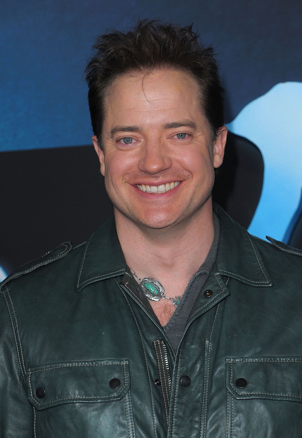 Brendan Fraser in a large green necklace and leather jacket at the Avatar premiere