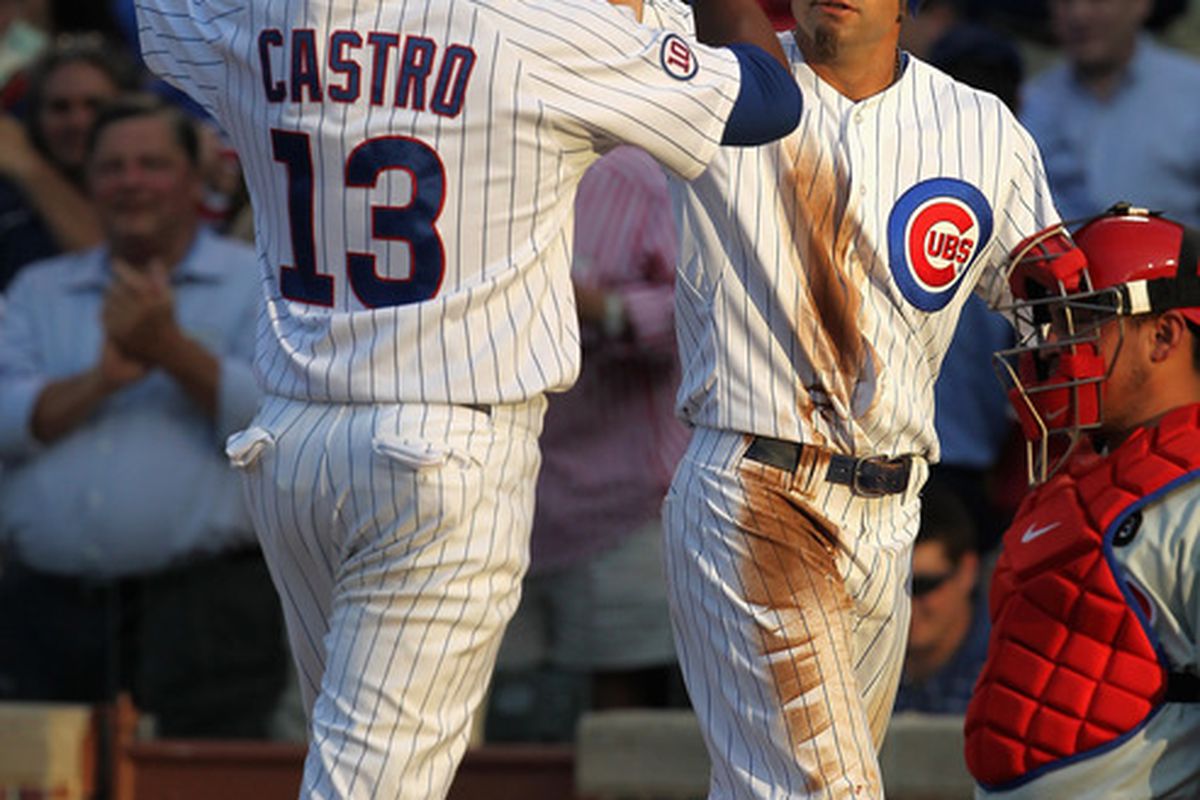 Reed Johnson of the Chicago Cubs greets teammate Starlin Castro after Castro hit a two-run home run against the Philadelphia Phillies at Wrigley Field in Chicago, Illlinois. (Photo by Jonathan Daniel/Getty Images)