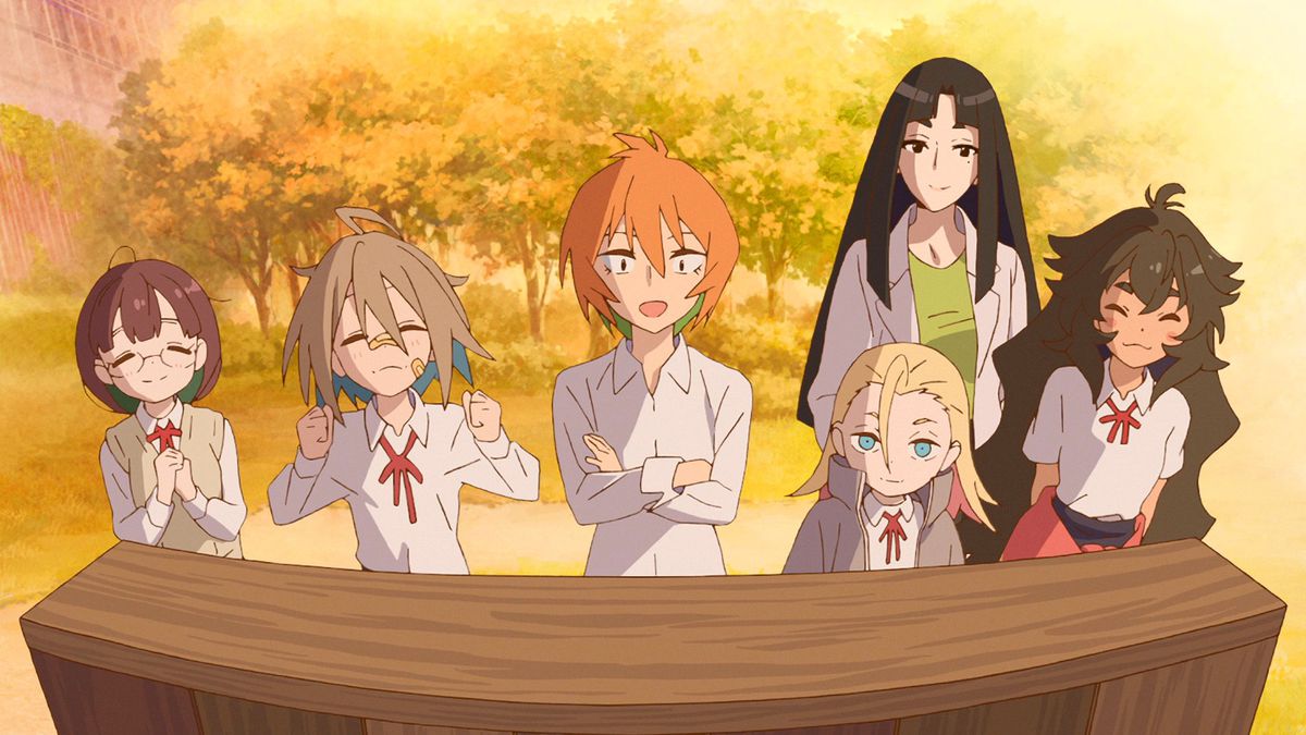 Five young anime girls and an older woman stand in front of a sign, visibly proud and excited.