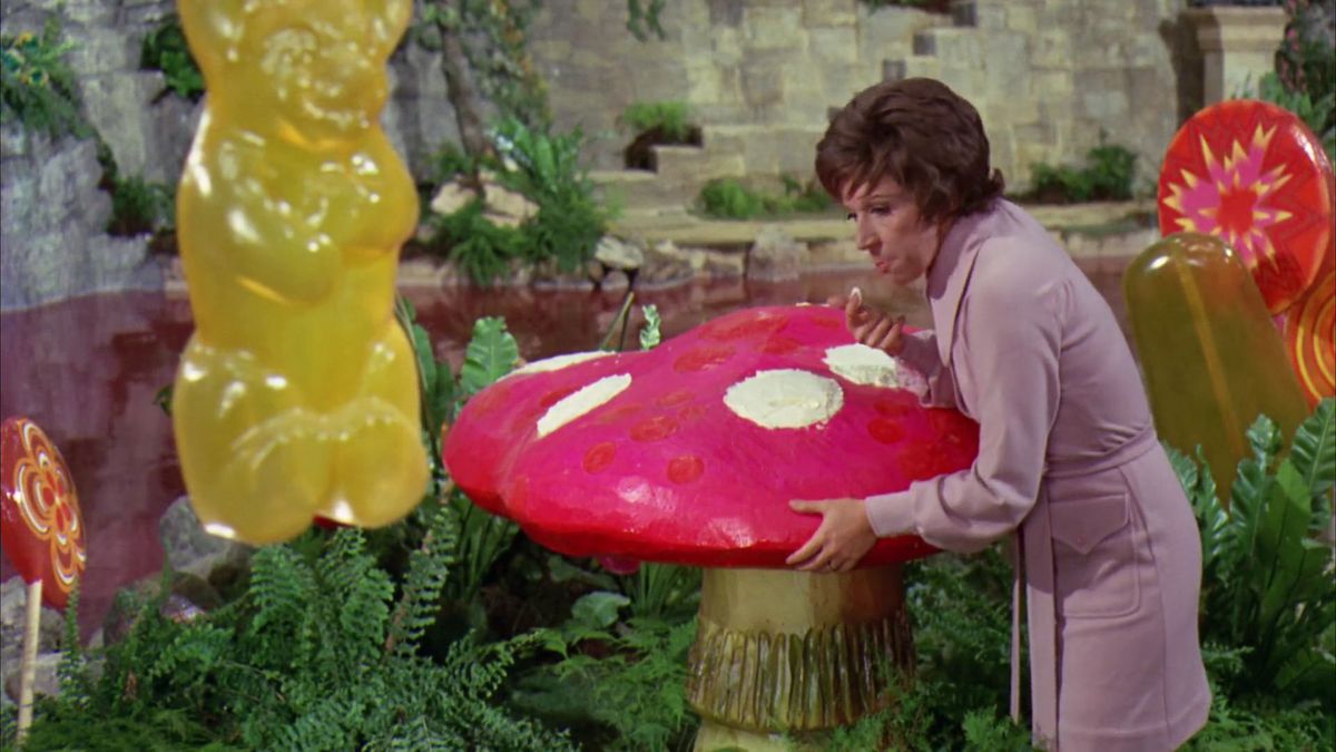 Mike Teavee’s mom leaning over to lick the cream off a giant mushroom