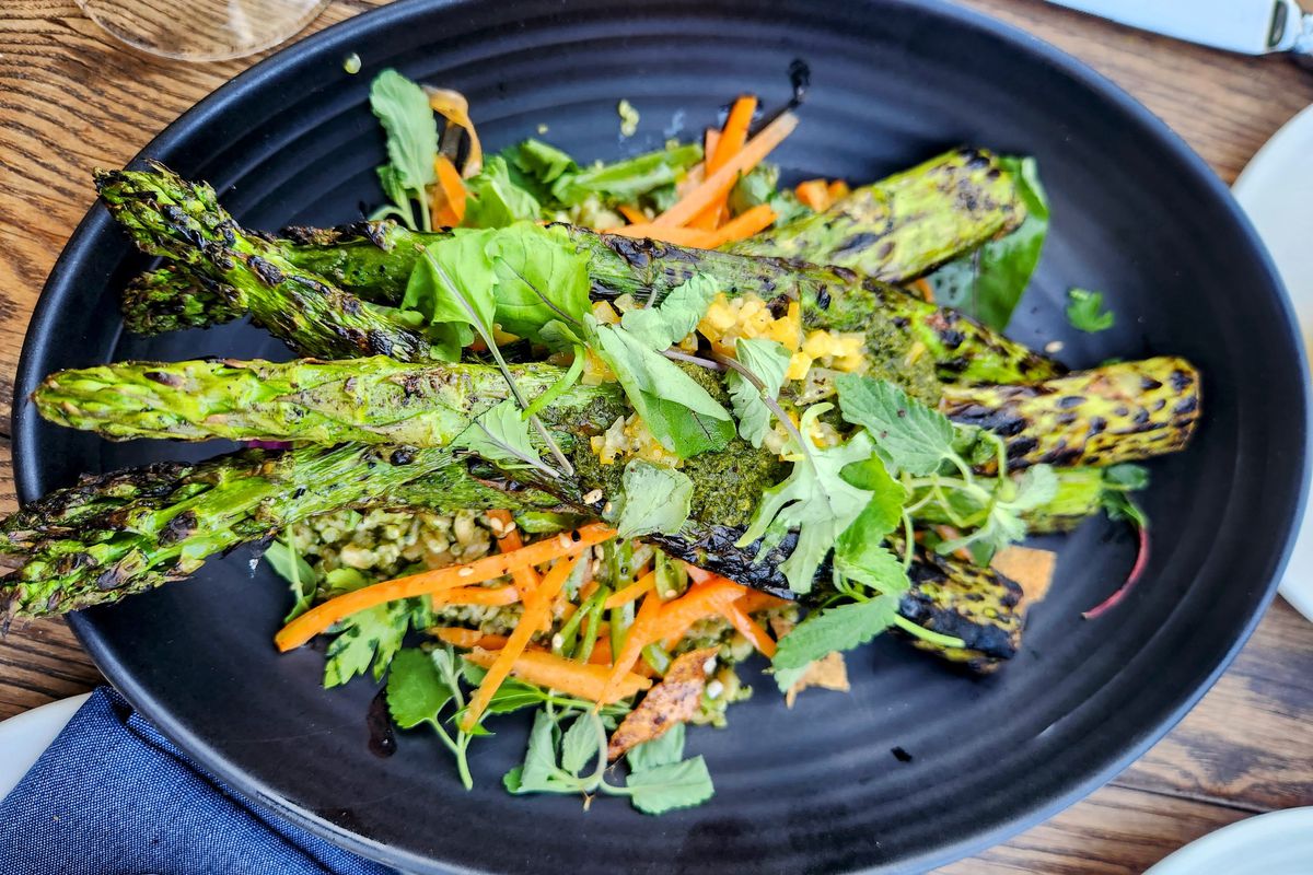 A blue plate filled with grilled asparagus and other vegetables at the Backyard at the Hollywood Bowl.