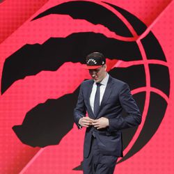 Jakob Poeltl walks off stage after being selected ninth overall by the Toronto Raptors during the NBA basketball draft, Thursday, June 23, 2016, in New York. 