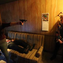 An actress, left, performs in “The Walking Dead Experience” during Salt Lake Comic Con's FanX at the Salt Palace Convention Center in Salt Lake City on Friday, March 25, 2016.