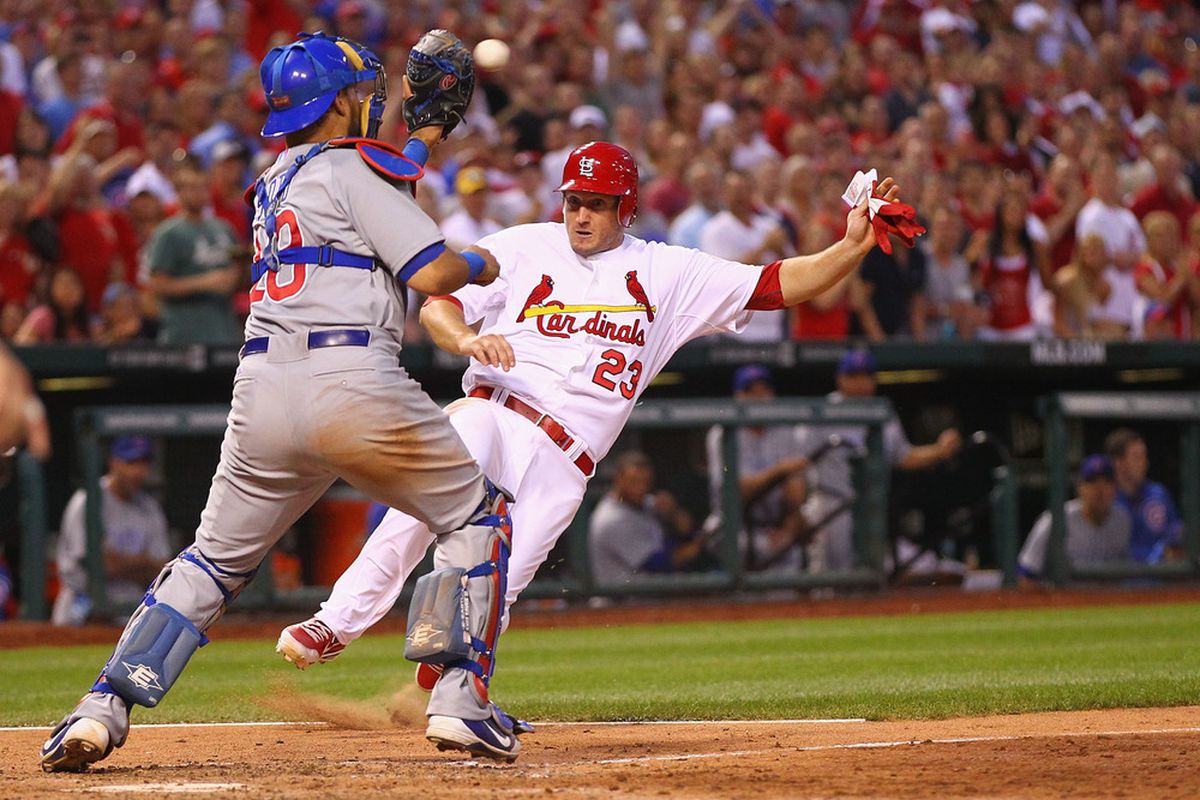ST. LOUIS, MO - MAY 14: David Freese #23 of the St. Louis Cardinals attempts to score a run against Geovany Soto #18 of the Chicago Cubs at Busch Stadium on May 14, 2012 in St. Louis, Missouri.  (Photo by Dilip Vishwanat/Getty Images)