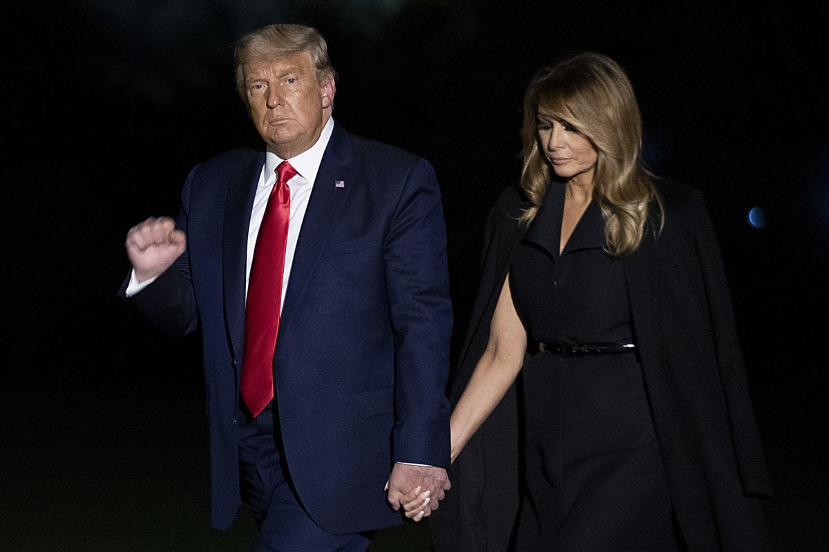 The president and first lady walking hand-in-hand.