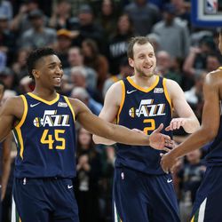 Utah Jazz guard Donovan Mitchell (45), forward Joe Ingles (2) and guard Rodney Hood (5) celebrate in the final moments of their 104-101 win over the Cleveland Cavaliers at Vivint Arena in Salt Lake City on Saturday, Dec. 30, 2017.