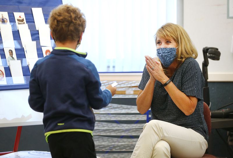 Teacher Beth Walz celebrates during a match game with Malo, a French-speaking student learning English, at J.E. Cosgriff Memorial Catholic School in Salt Lake City on Monday, June 22, 2020. The school is offering a modest summer program for students.