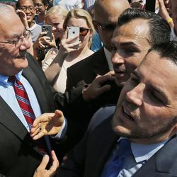 Plaintiffs in the California Proposition 8 gay marriage case Paul Katami, center, and his partner Jeff Zarrillo, greet former Massachusetts Rep. Barney Frank in front of the Supreme Court in Washington, Wednesday, June 26, 2013. In a major victory for gay rights, the Supreme Court on Wednesday struck down a provision of a federal law denying federal benefits to married gay couples and cleared the way for the resumption of same-sex marriage in California. 