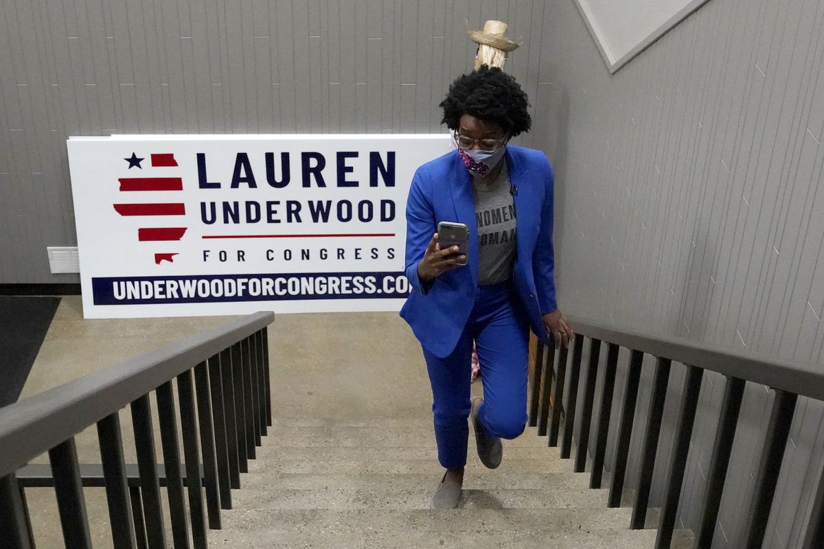 Congresswoman Lauren Underwood checks her phone as she walks up her office at an election night headquarter in St. Charles, Ill., Tuesday, Nov. 3, 2020. Lauren Underwood of Naperville and Jim Oberweis of Sugar Grove are the candidates for the 14th U.S. Congressional District seat. (AP Photo/Nam Y. Huh) ORG XMIT: ILNH104