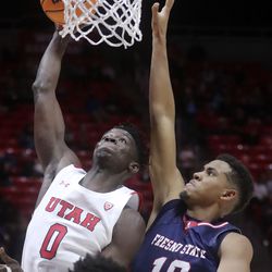 Utah Utes center Lahat Thioune (0) shoots in front of Fresno State Bulldogs forward Orlando Robinson (10) during a men’s basketball game at the Huntsman Center in Salt Lake City on Tuesday, Dec. 21, 2021. Utah won 55-50.