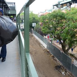 Mon 5:51 p.m. Trash being taken out, on the walkway behind the right field patio, with a view of Sheffield below - 